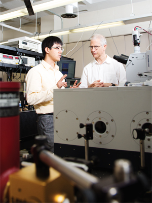 Nanfang Yu (left) and Michael Weinstein in Yu’s optics lab. 