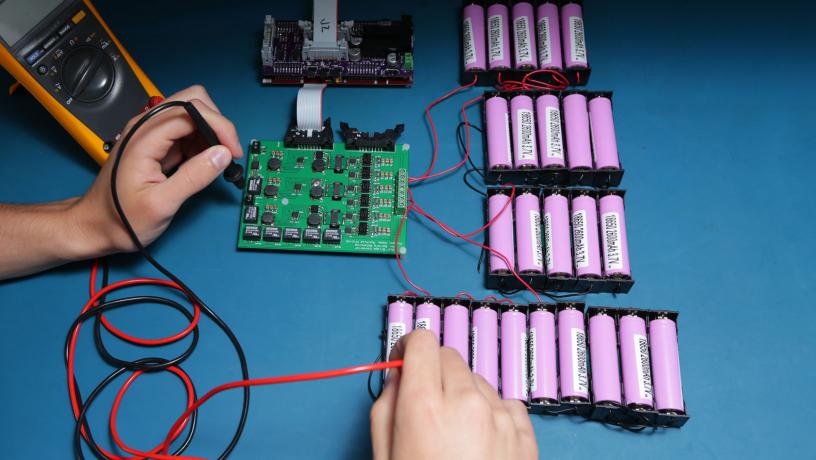 Student working to optimize the performance of battery-packs.