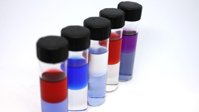 5 tubes with colorful liquid showing fresh water production from hypersaline brines.