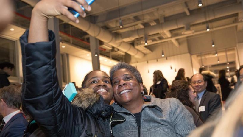 A student taking a selfie with Ursula Burns.
