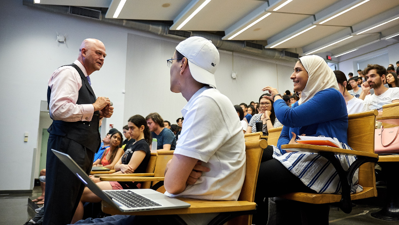 A group of students interacting with faculty member Helio Fred Garcia during an Art of Engineering lecture.