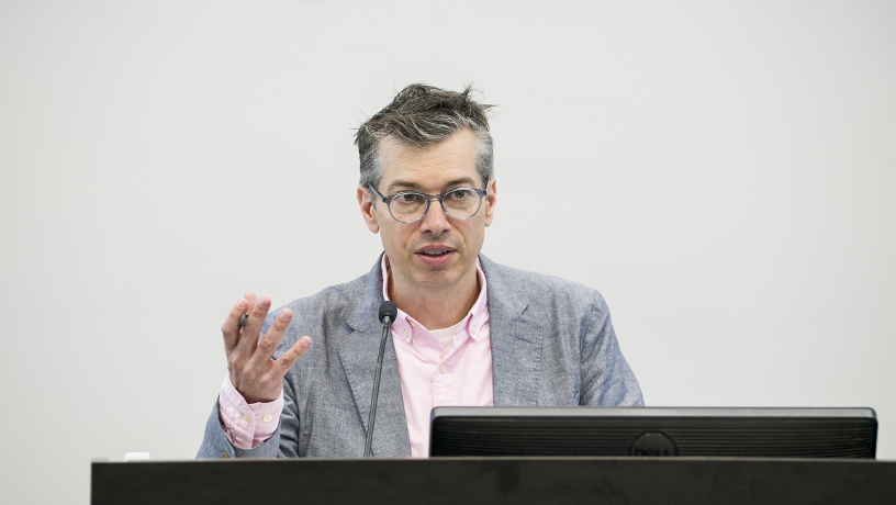 Prof. Chris Wiggins addressing the audience during a lecture.