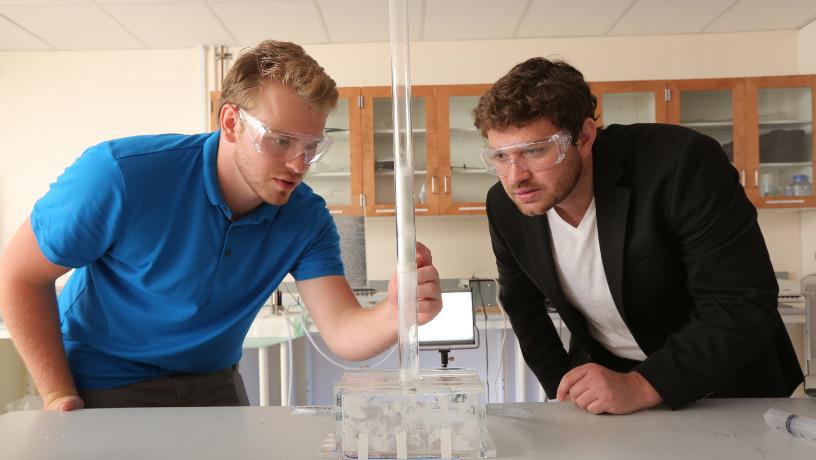 Prof. Chris Boyce working with a student in his lab.