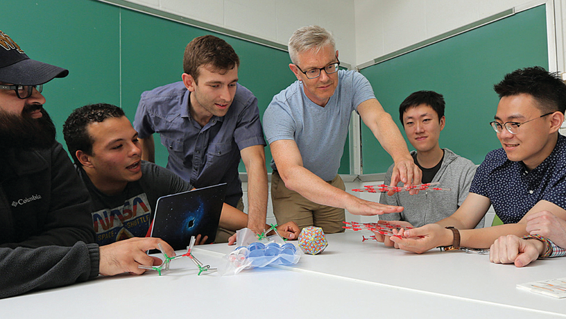 Prof. Simon Billinge working with students and researchers in his lab.