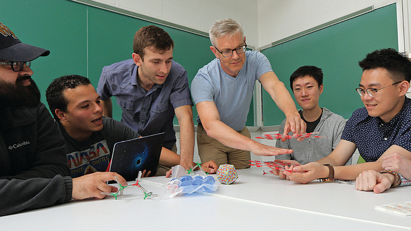 Prof. Simon Billinge working with students and researchers in his lab. 