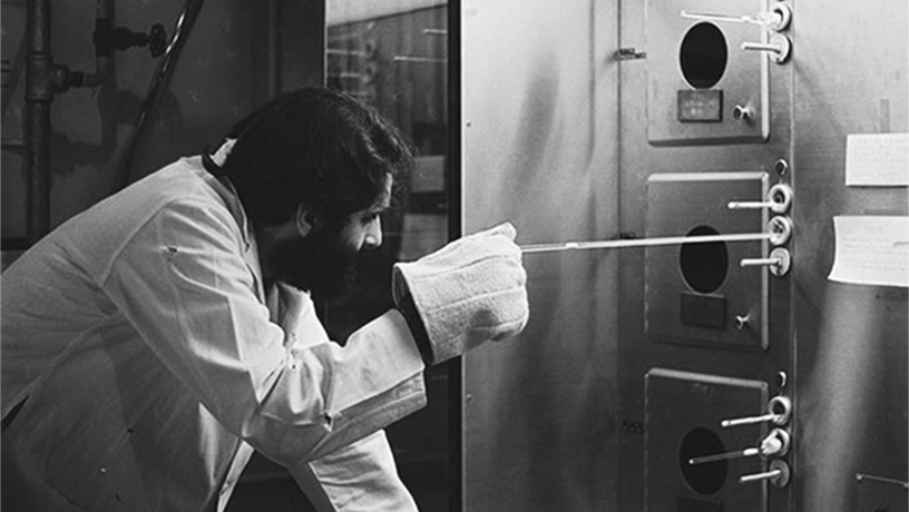 Black and white picture of Tsividis as a graduate student working in a lab at Berkeley.